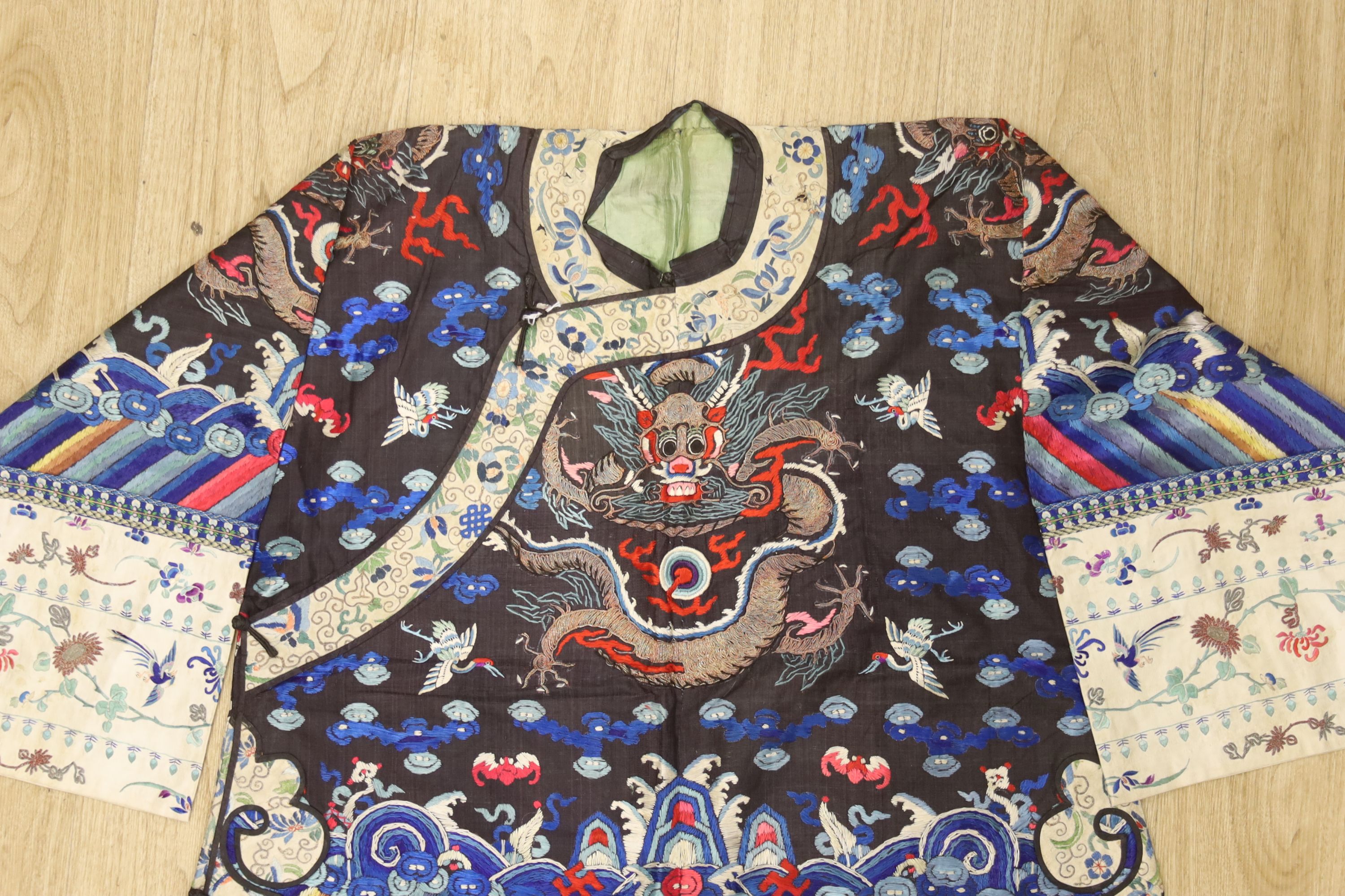 An early 20th century Chinese dragon embroidered silk robe, length 71cm